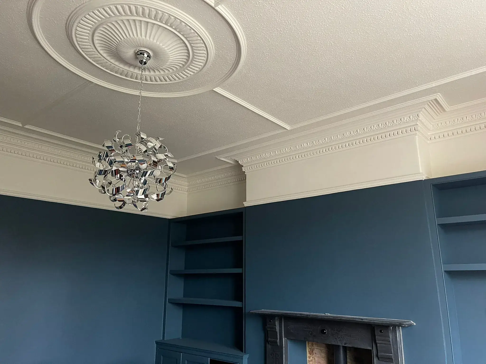 Living room ceiling with coving painted, blue walls in Newcastle by Tulip Decor